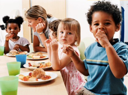 Children at a childcare center eating together